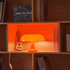 Classic Mushroom Italian LED Lamp on a wooden bookshelf with an orange lamp