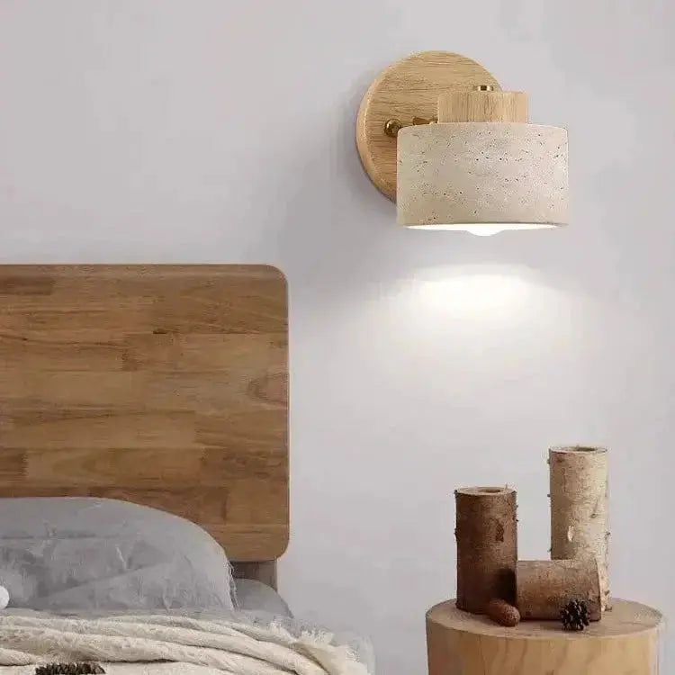 Zenvia Essentials Minimalist Travertine Stone LED Wall Light mounted on a white wall in a bedroom