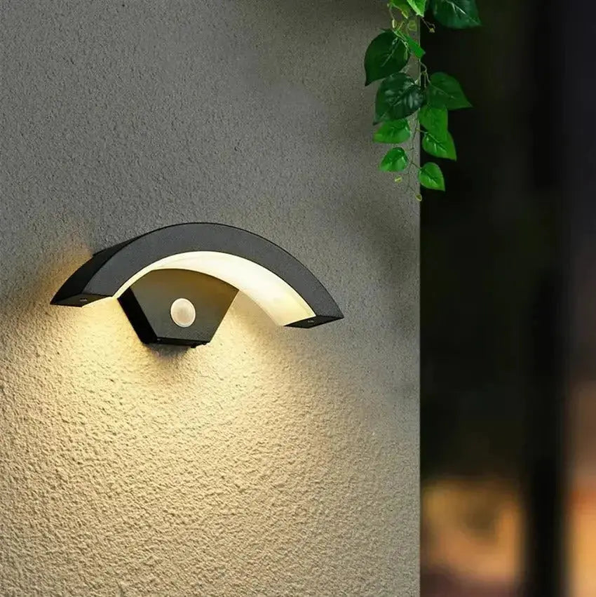 Zenvia Essentials Modern Curved LED Motion Sensor Wall Light on beige wall