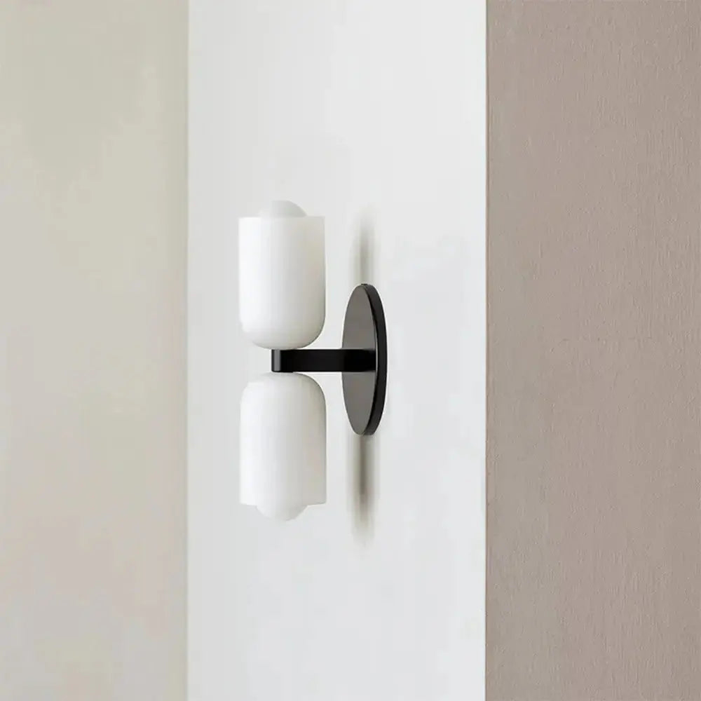 Zenvia Essentials Modern Up Down Acrylic Wall Light with white glass shades on a black metal bracket
