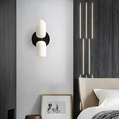 Zenvia Essentials Modern Up Down Acrylic Wall Light mounted above a bed in a minimalist bedroom