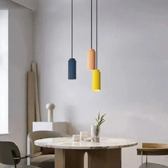 Zenvia Essentials Nordic Minimalist Pendant Light hangs above a wooden dining table in a modern room.