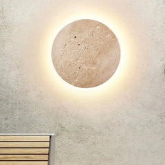 Zenvia Essentials Stone-Inspired Round Wall Lamp with smooth surface, turned on, on white wall