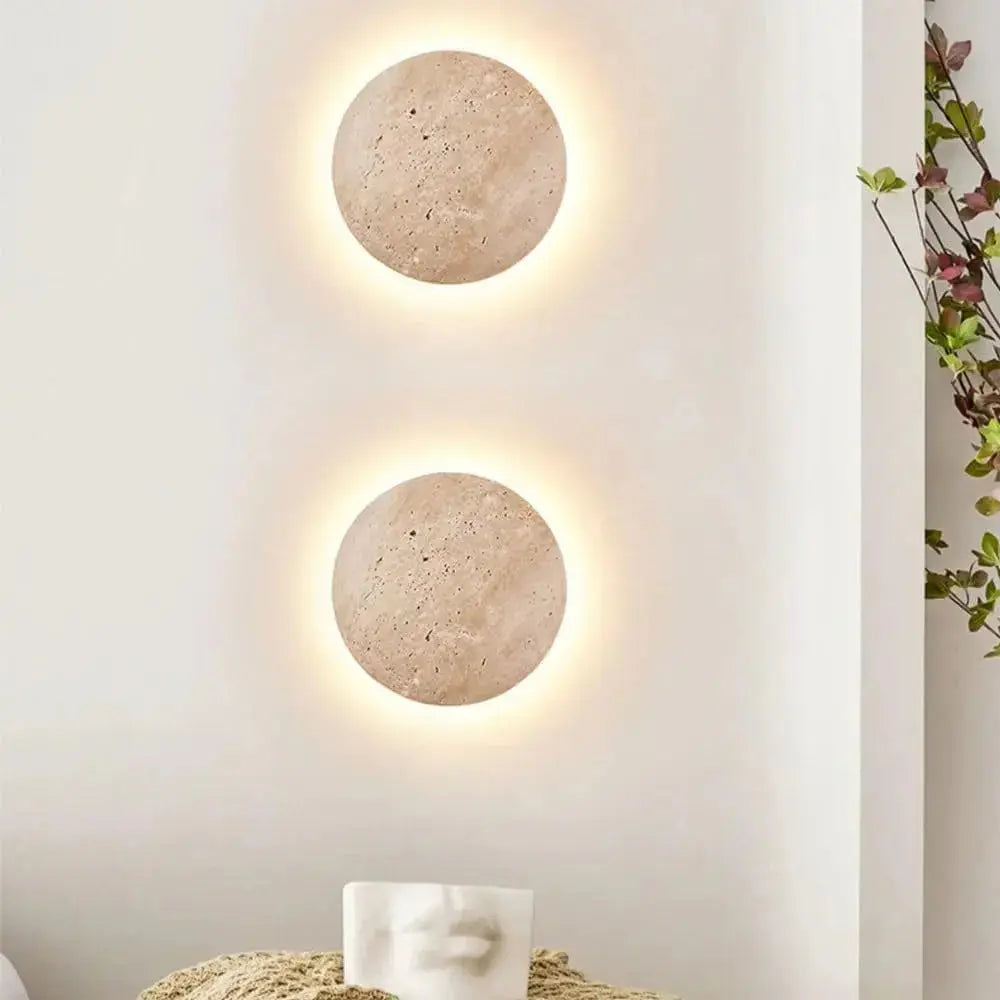 Two Zenvia Essentials Stone-Inspired Round Wall Lamps mounted on a white wall with stone-textured surfaces