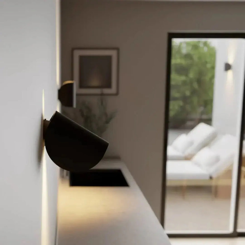 Zenvia Essentials Up & Down Modern Wall Sconce Light on a white wall in a living room
