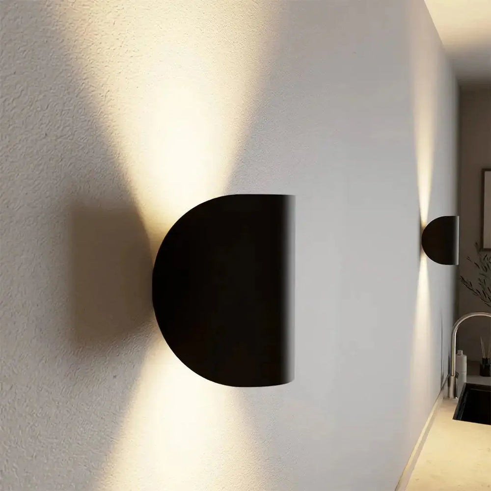 Zenvia Essentials Up & Down Modern Wall Sconce Light, a black circular wall-mounted light fixture