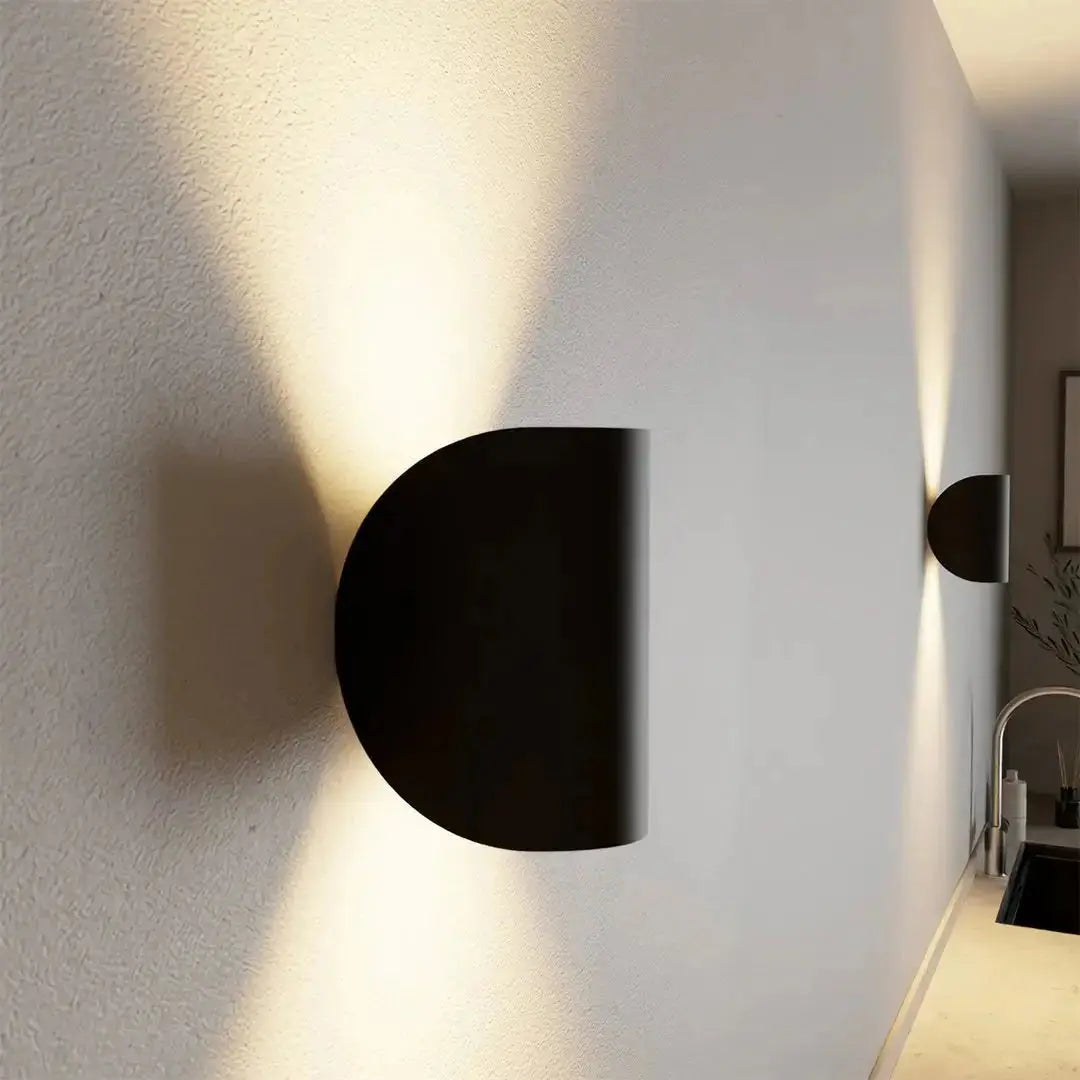 Zenvia Essentials Up & Down Modern Wall Sconce Light, a black circular wall-mounted light fixture